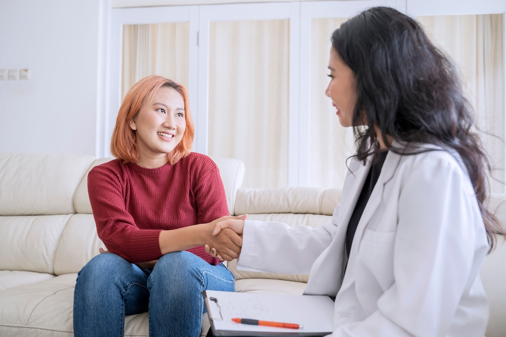 happy,therapy,session,,smiling,patient,shaking,hands,with,counselor